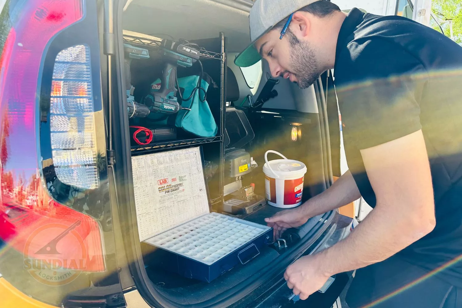 Our tech at Sundial Locksmith working inside a van with tools and equipment.
