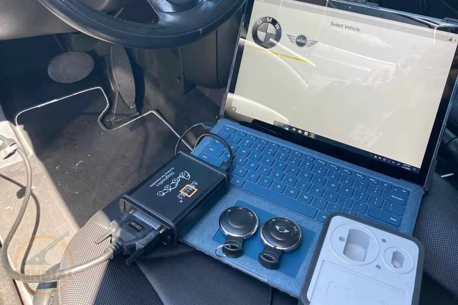 Laptop and diagnostic tools in car for vehicle servicing.