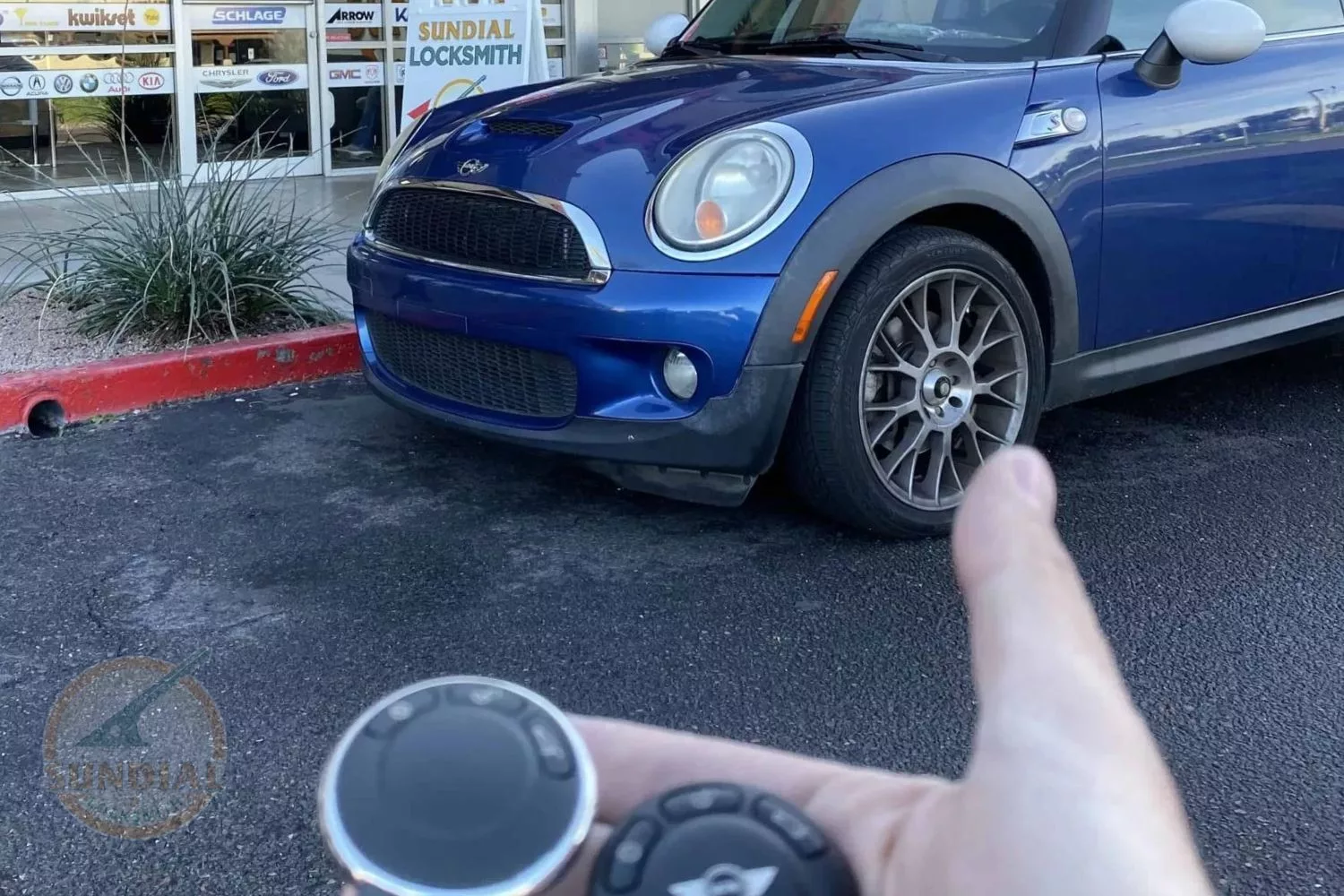 Blue Mini Cooper with key fob in foreground.