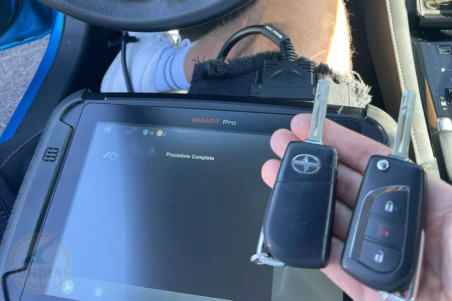 Technician programming keys inside a Scion vehicle
