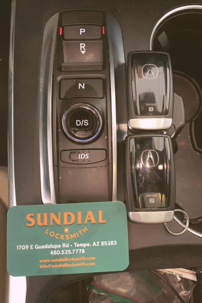 Car gear selector, memory seat buttons, locksmith business card.