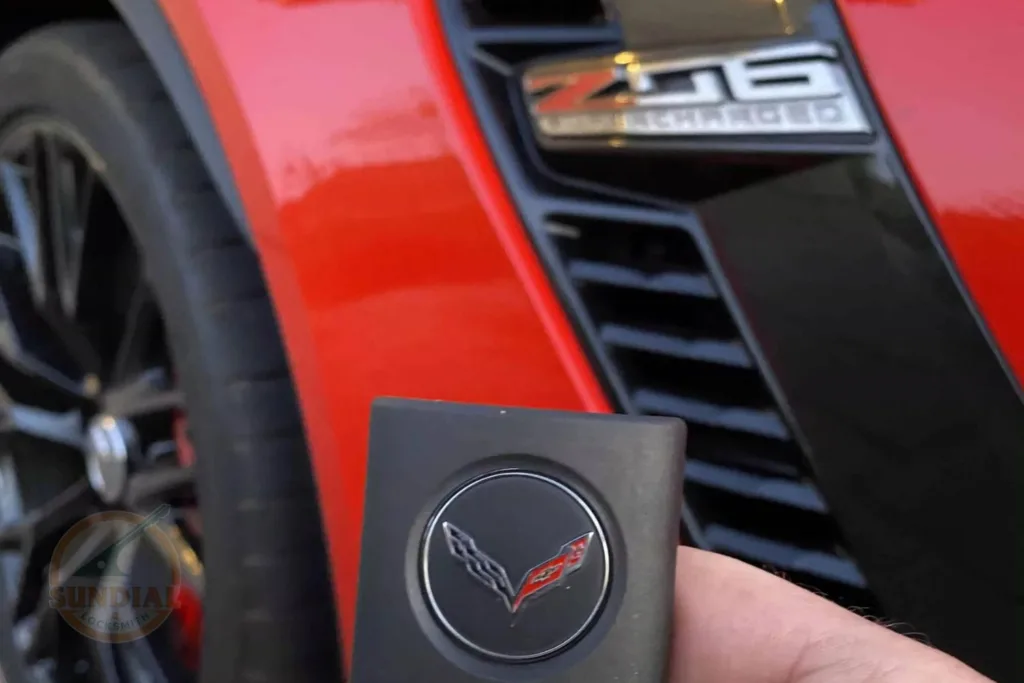 Red Corvette Z06 with key fob in foreground.