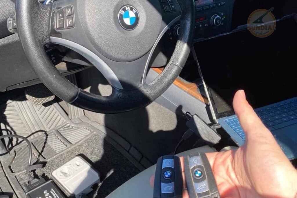 Ford F-Series Truck Key Replacement: What Every Owner Should Know A technician holds a BMW key fob inside a BMW vehicle while diagnostic equipment is connected to the dashboard for key programming.