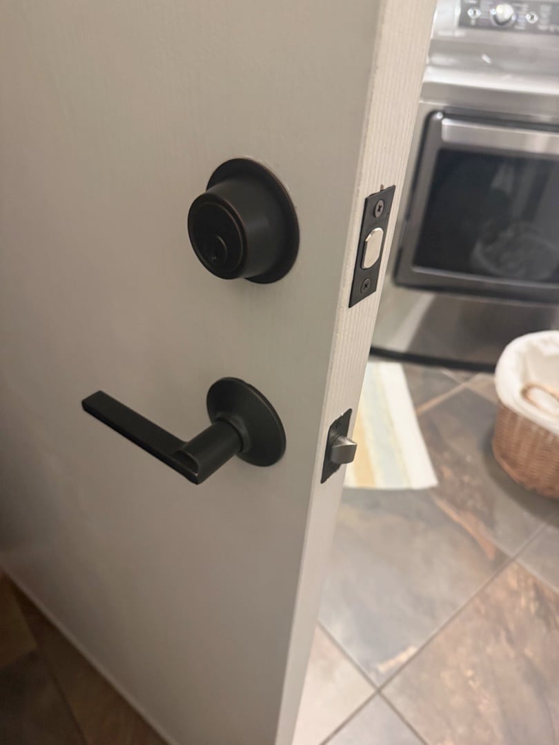 Window Lock Installation: A Small Upgrade with a Big Security Impact A locksmith performing window lock installation on a double-hung window inside a bright Arizona home, demonstrating professional home window security locks.