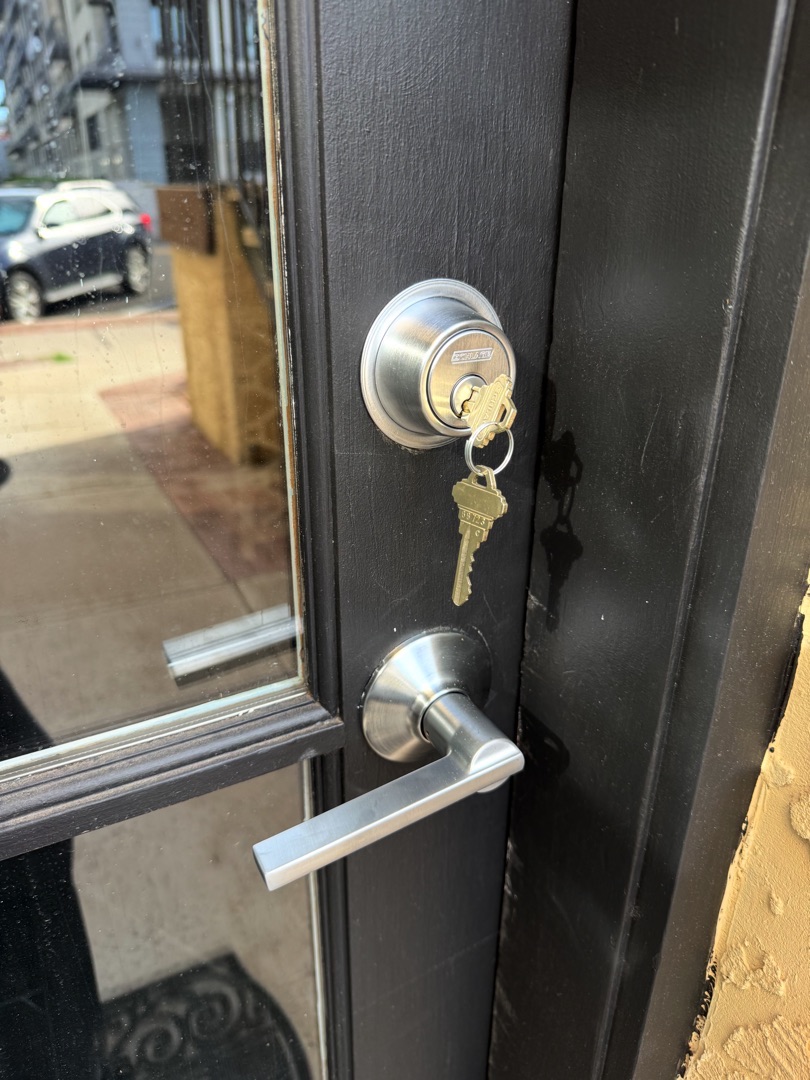 Same-Day Deadbolt Replacement: When to Skip the Hardware Store Trip A locksmith performing same day deadbolt replacement on a residential front door in bright Arizona afternoon sunlight