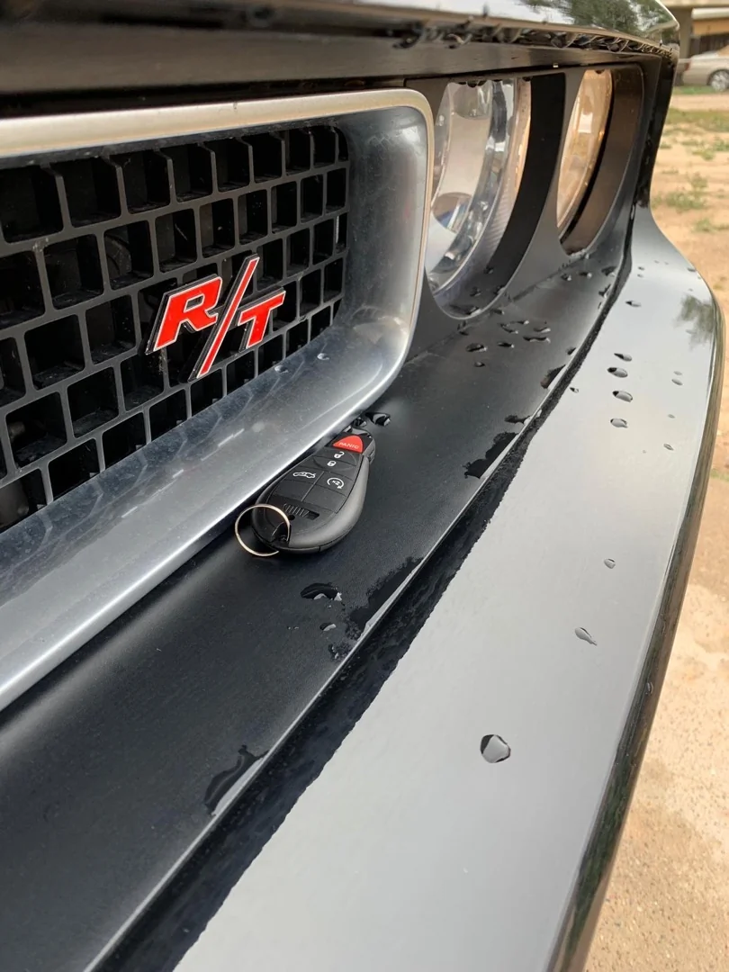 Stuck Key in the Ignition: What to Do Before You Force It A locksmith technician carefully performing a stuck key in ignition removal at a vehicle in an outdoor parking area during daytime
