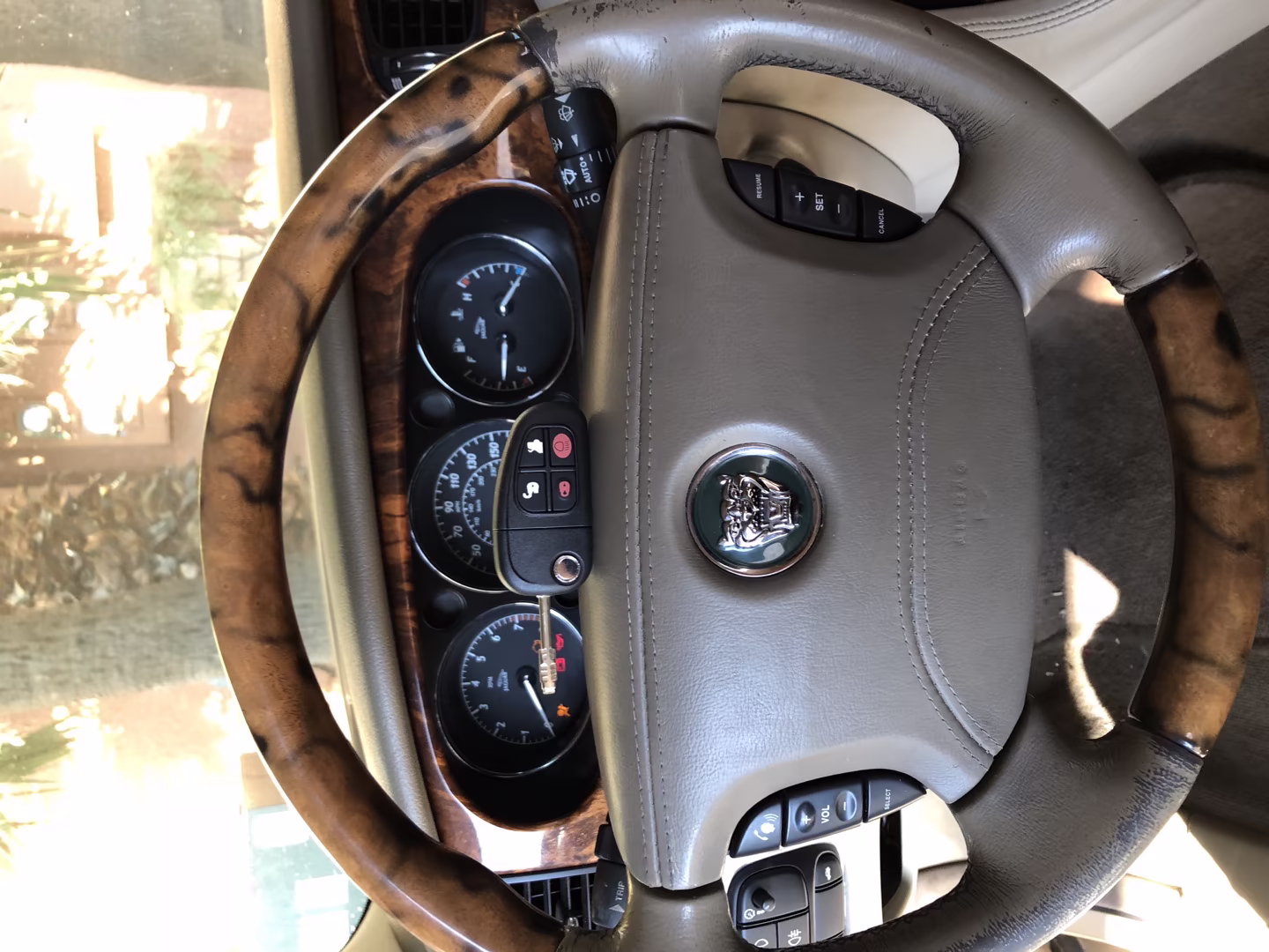 Signs Your Ignition Cylinder Is Failing Before It Strands You A locksmith technician closely inspecting a vehicle ignition cylinder outdoors, illustrating signs your ignition needs replacing diagnosis during a real service call
