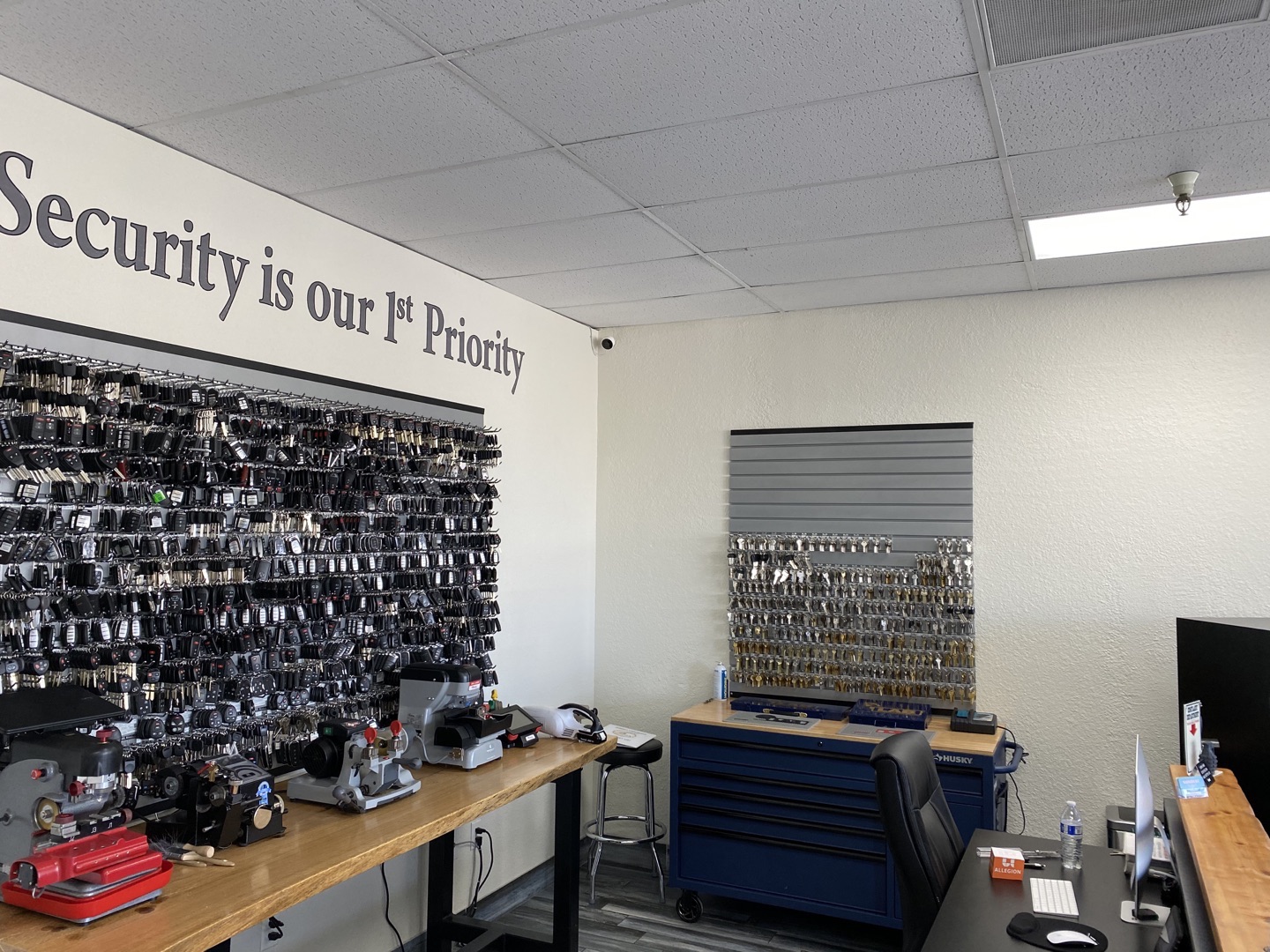 What Makes a Lock 'High Security' — and Is It Worth the Extra Cost? A locksmith installing a what is a high security lock deadbolt on a residential front door in warm Arizona afternoon light, showing the precision cylinder and hardened steel faceplate up close.
