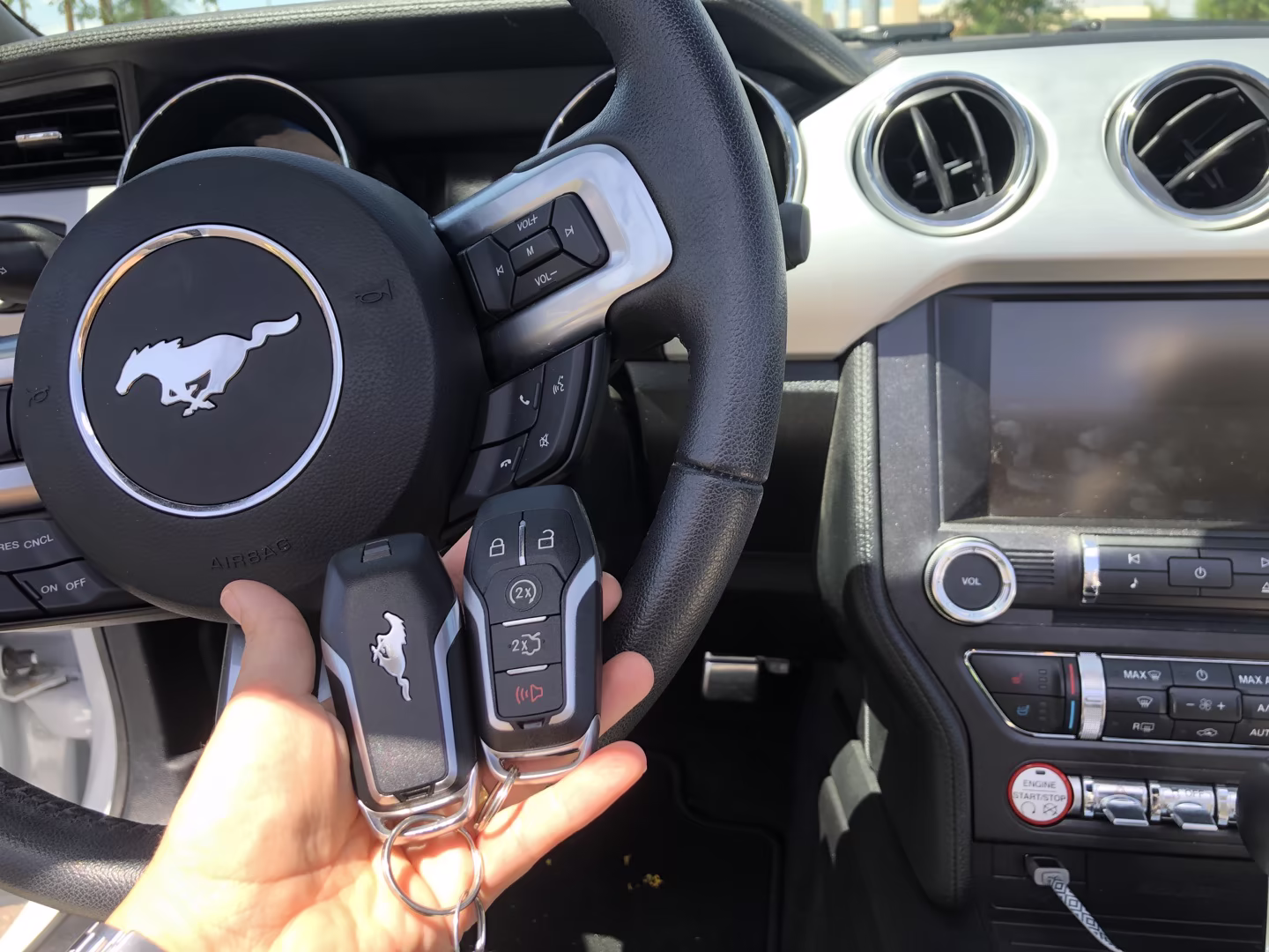 Ford F-Series Truck Key Replacement: What Every Owner Should Know A professional locksmith cutting a Ford truck key on a precision key cutting machine — expert locksmith for ford f series service in a real shop setting